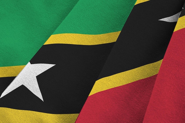 Saint Kitts and Nevis flag with big folds waving close up under the studio light indoors The official symbols and colors in banner