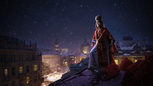 Saint nicholas  sinterklaas  dutch santa on top of the roof of night winter city