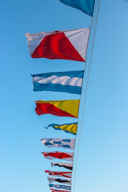 Saint Petersburg Russia International maritime signal flags are waving on wind under blue cloudy sky