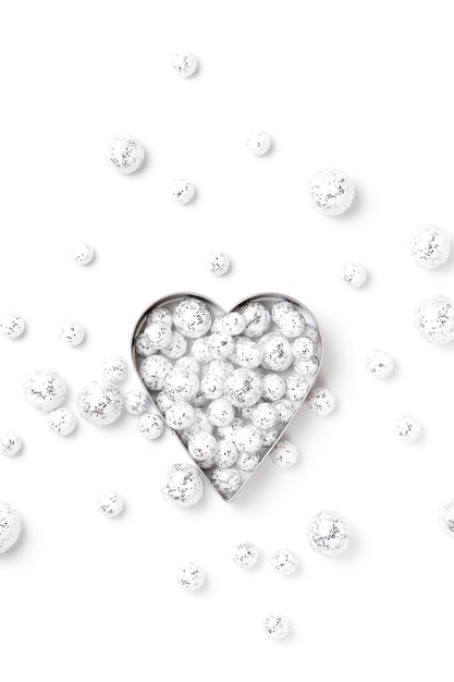 Saint Valentine`s day greeting card,  heart symbol in silver glitter balls on white, minimal festive frame