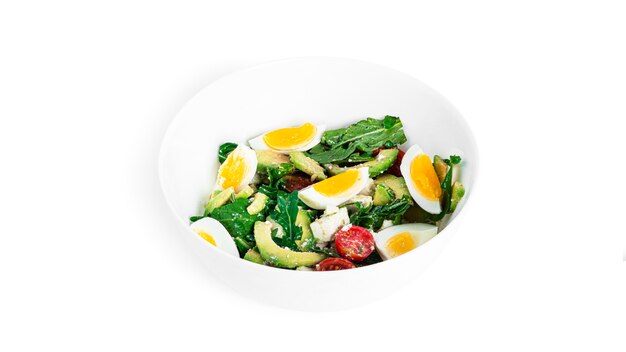 Salad of arugula, avocado, cherry tomatoes and eggs isolated on a white background. Green salat. Vegetarian salad. High quality photo