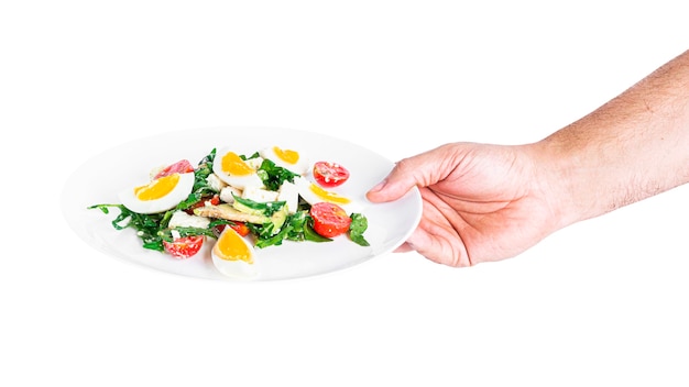 Salad of arugula, avocado, cherry tomatoes and eggs isolated on a white background. Green salat. Vegetarian salad. High quality photo