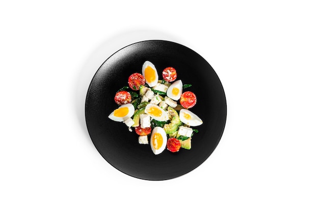 Salad of arugula, avocado, cherry tomatoes and eggs isolated on a white background. Green salat. Vegetarian salad. High quality photo