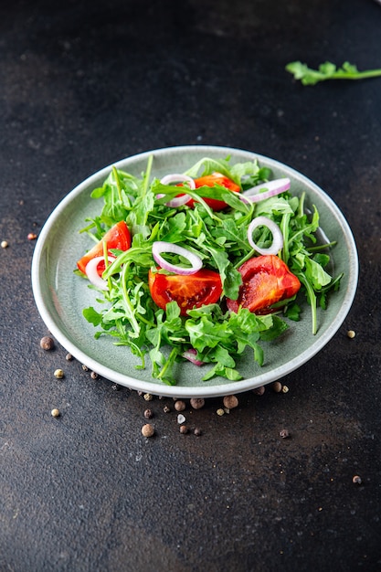 Salad arugula tomato onion fresh vegetable plate meal snack on the table copy space food