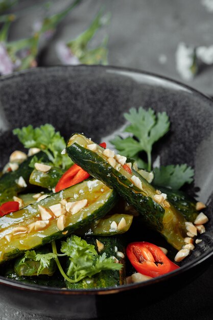 Salad of broken cucumbers with sesame seeds, sugar, red and black pepper, olive oil