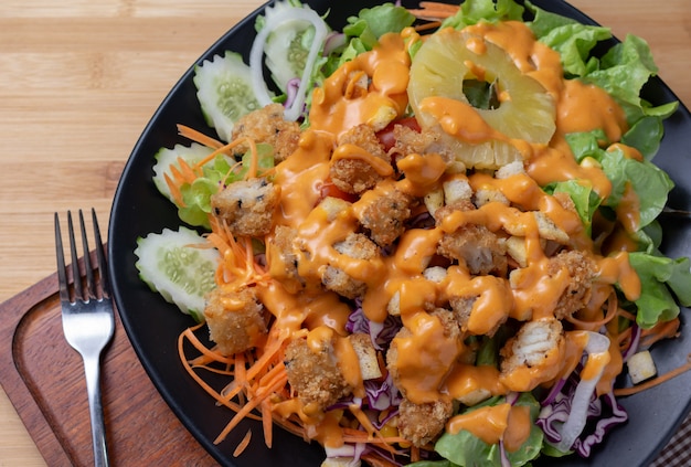 Salad and cheese dressing on table