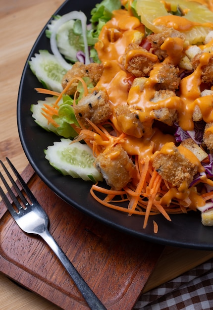 Salad and cheese dressing on table