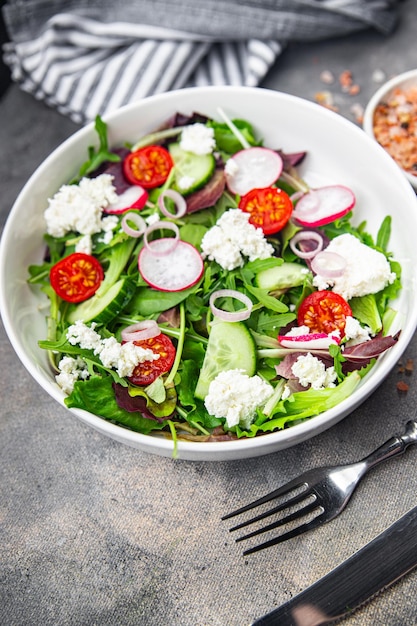 salad cheese green leaves vegetable radish tomato cucumber meal food snack on the table