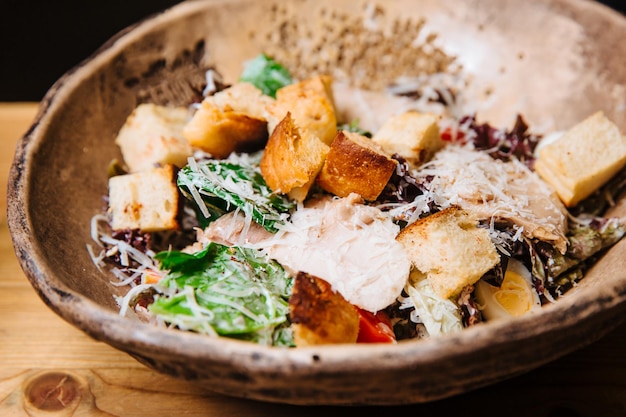 Salad of chicken breast slices green salad Parmesan cheese and croutons