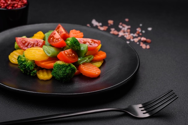 Salad of fresh and steamed vegetables cherry tomatoes broccoli and carrots