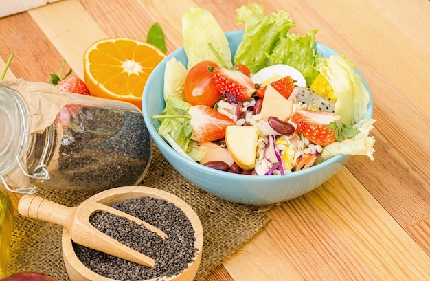 Salad fresh vegetables and fruit on wooden table