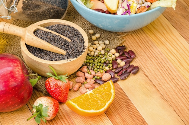 Salad fresh vegetables and fruit on wooden table