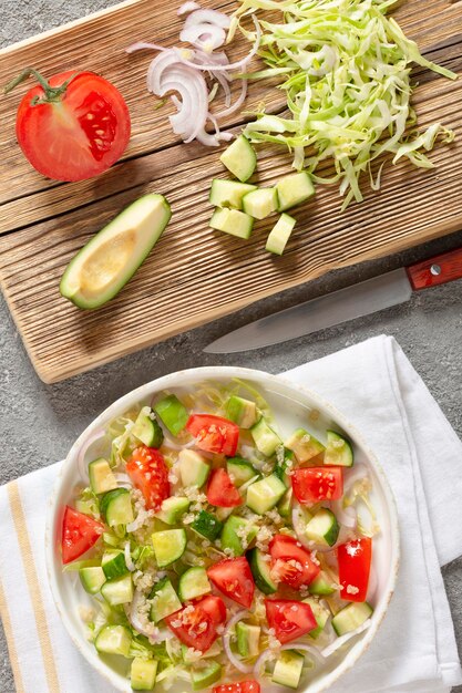 Salad of fresh vegetables and herbs with quinoa seeds and olive oil