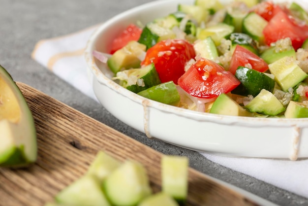 Salad of fresh vegetables and herbs with quinoa seeds and olive oil