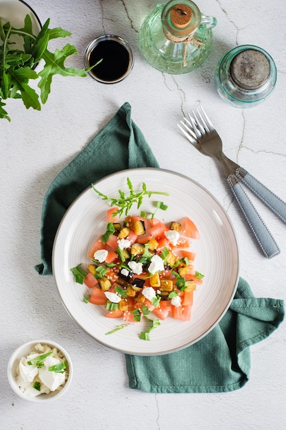 Salad of fried eggplant tomato ricotta and arugula Homemade lunch Top and vertical view