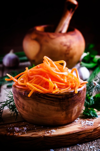 Salad from marinated carrots Vintage wooden background selective focus