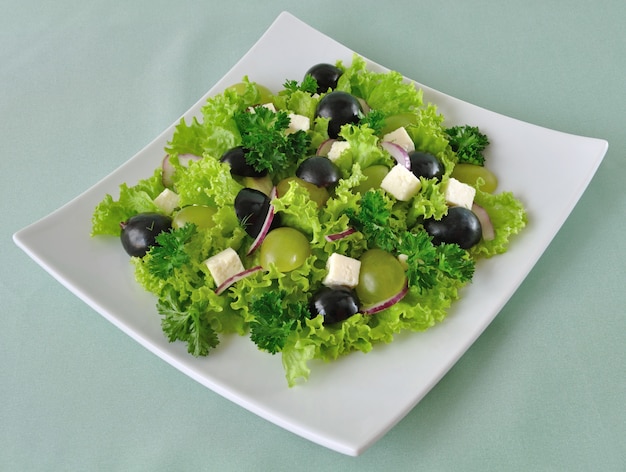 Salad of lettuce with cheese and grapes of different varieties