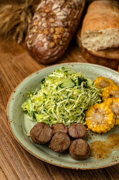 Salad meat and corn  a hearty lunch on a wooden table