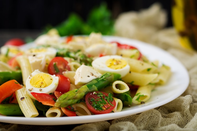 Salad - penne pasta with asparagus, tomatoes, quail eggs, mozzarella