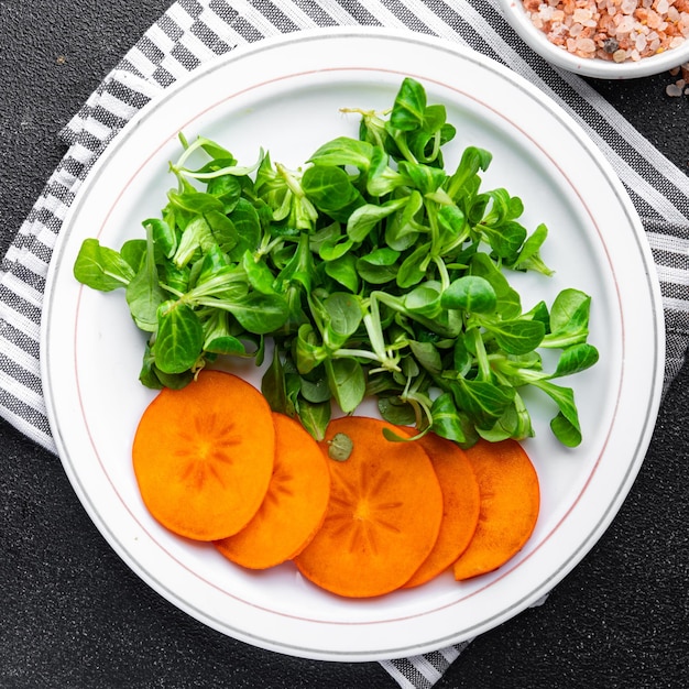 salad persimmon green lettuce fresh meal food snack on the table copy space food background rustic