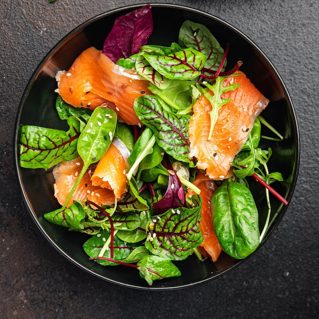 Salad salmon slices green salad mix seafood fresh portion dietary healthy meal food diet snack