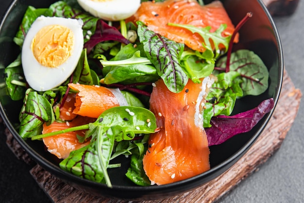 Salad salted salmon eggs green leaves lettuce fresh portion healthy meal food diet snack