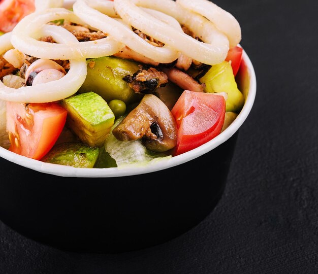 Salad Squid with baked vegetables closeup