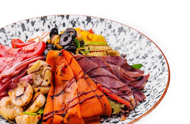 salad of various meats with mushrooms carrots and lettuce leaves