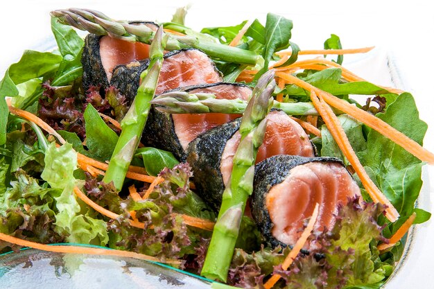 Salad with asparagus and fried tuna on a white background