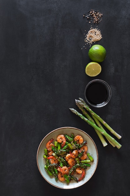 Salad with asparagus and shrimps in plate