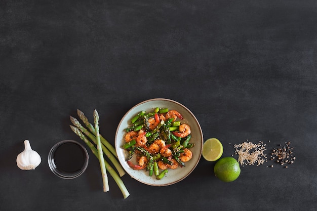 Salad with asparagus and shrimps in plate