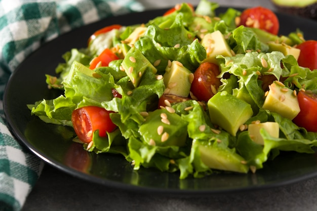 Salad with avocado, lettuce, tomato and flax seeds