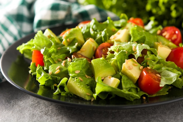 Salad with avocado, lettuce, tomato and flax seeds