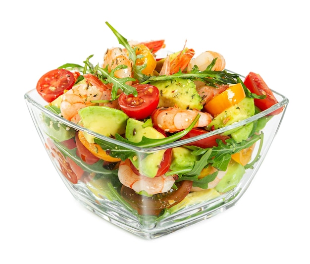 Salad with avocado shrimp fresh cherry tomatoes and arugula in glass bowl