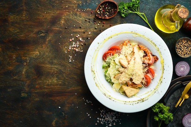 Salad with chicken and bacon Top view On a dark background Cold snacks