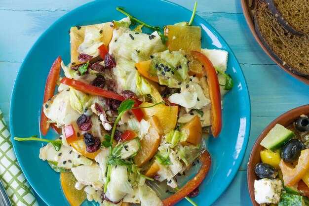 Salad with chicken and cheese with greens persimmon bell pepper The concept of diet food