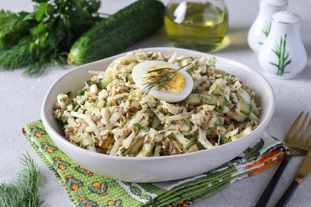 Salad with Chinese cabbage tuna and cucumber garnished with half an egg Closeup