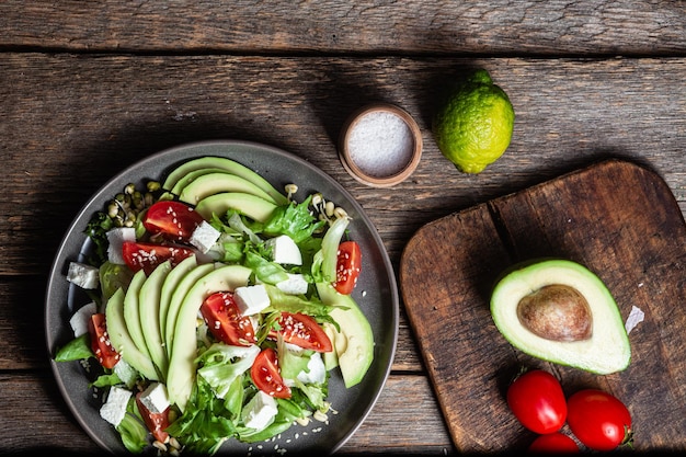 Photo salad with feta cheese avocado and tomatoes in a bowl