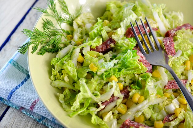 Salad with fresh cabbage and corn on a plate