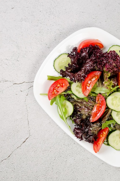 Salad with fresh salad leaves arugula cherry tomato cucomber