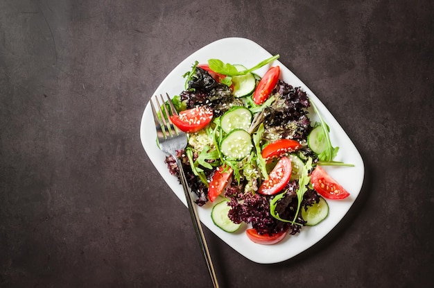 Salad with fresh salad leaves arugula cherry tomato cucomber