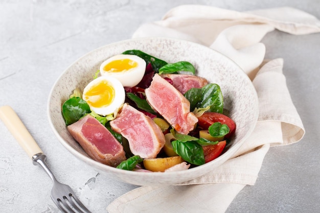 salad with fresh tuna egg potatoes and herbs