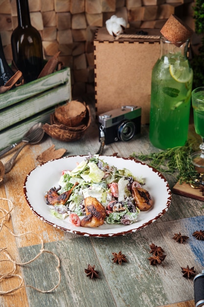 Photo salad with fried quail mushrooms and greens