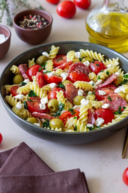 Salad with fusilli pasta sausage olives and cottage cheese Italian food