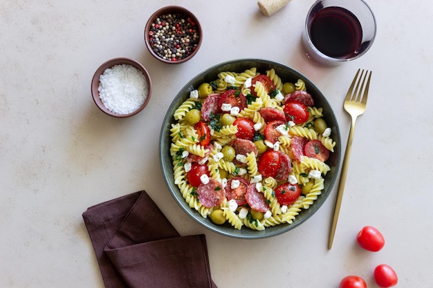 Salad with fusilli pasta sausage olives and cottage cheese Italian food