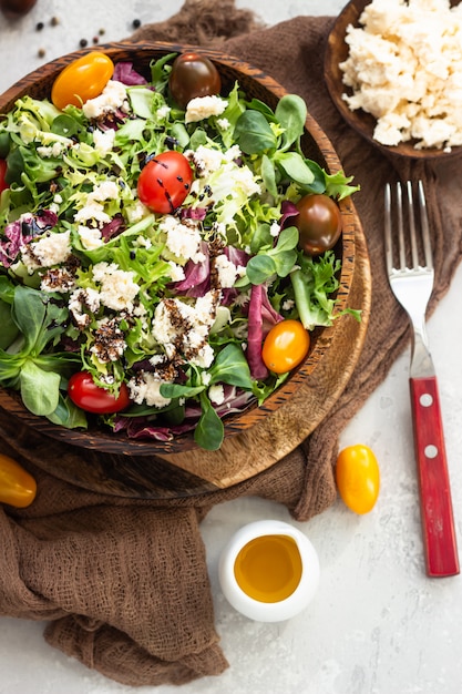 Salad with mix salad leaves, cherry tomatoes, ricotta and balsamic