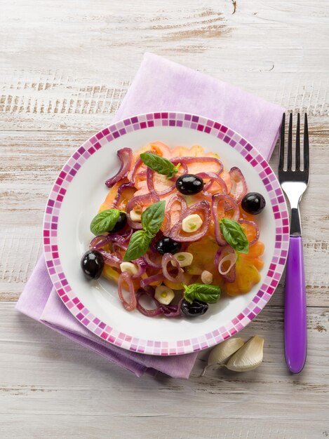 Salad with ox heart tomatoes onions olives and garlic