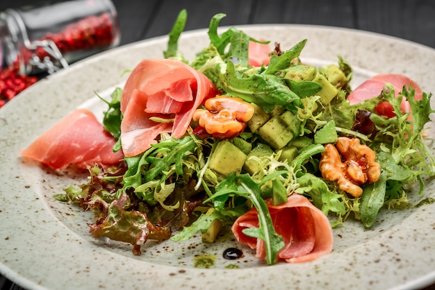 Salad with parma ham jamon , tomatoes and arugula