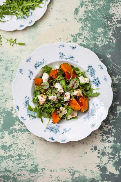 Salad with roasted pumpkin, arugula and homemade cheese