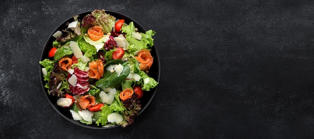 Salad with salmon parmesan cheese tomatoes and salad mix Banner